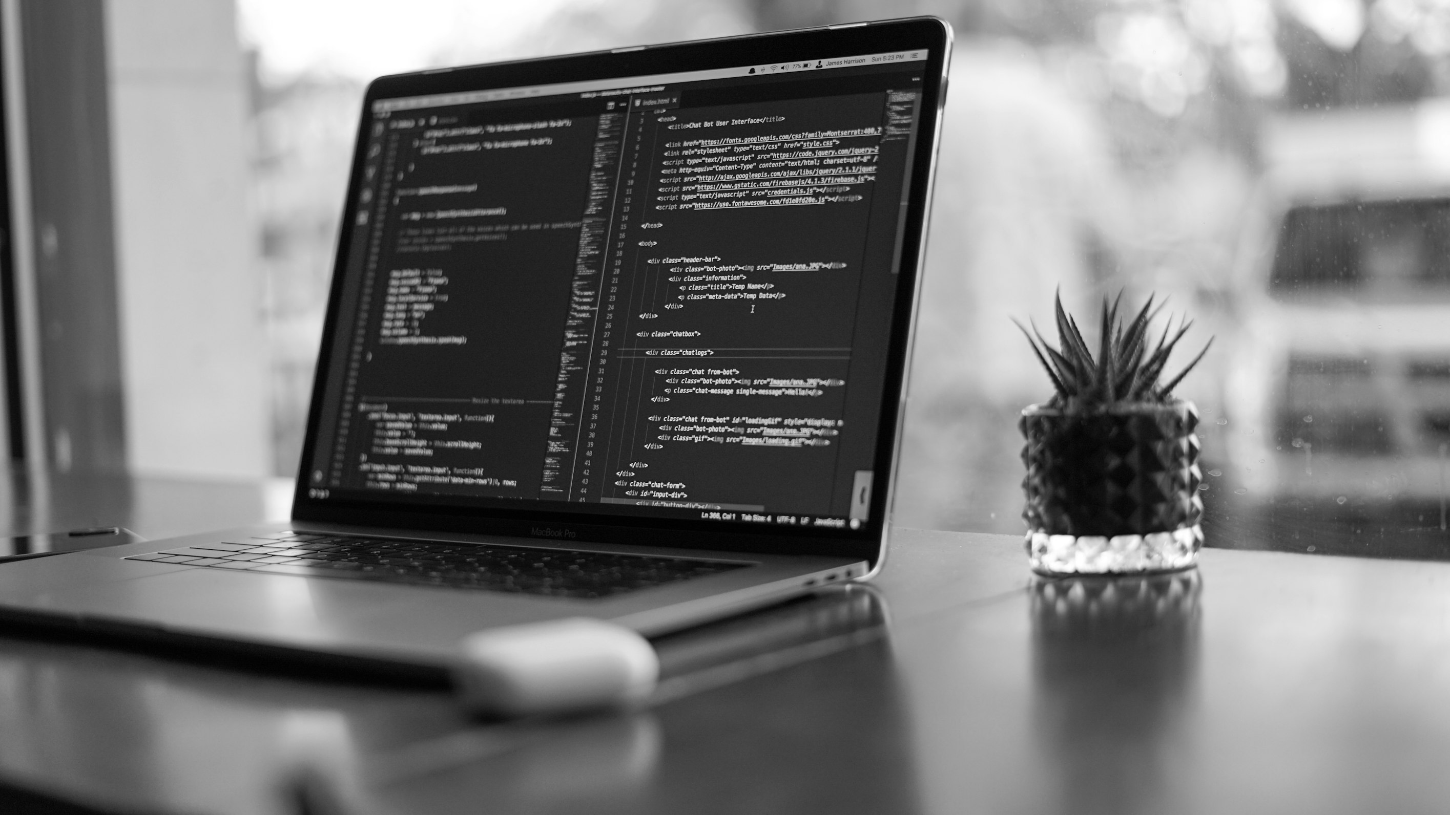 People working on laptops in a modern office environment